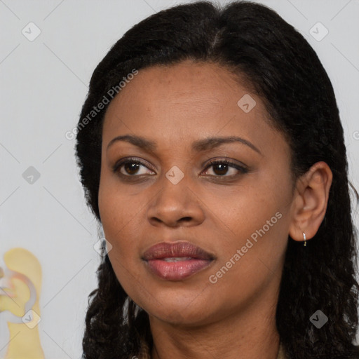 Joyful black adult female with long  black hair and brown eyes