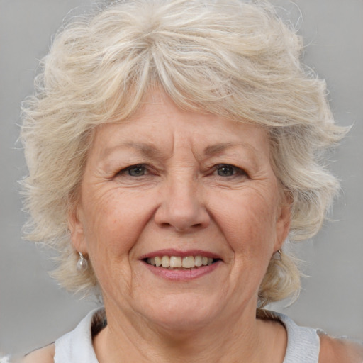 Joyful white middle-aged female with medium  blond hair and brown eyes