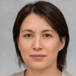 Joyful white adult female with medium  brown hair and brown eyes