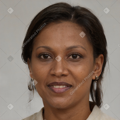 Joyful black adult female with medium  brown hair and brown eyes