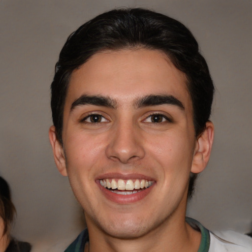 Joyful white young-adult male with medium  brown hair and brown eyes