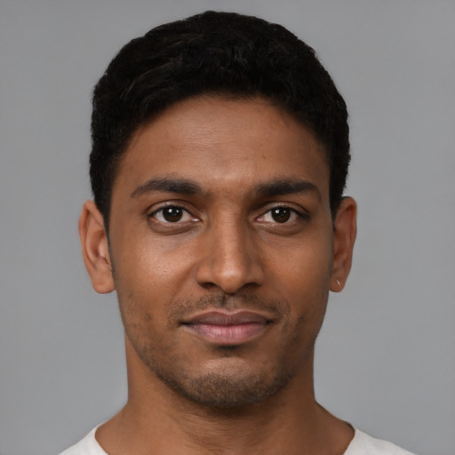 Joyful black young-adult male with short  black hair and brown eyes