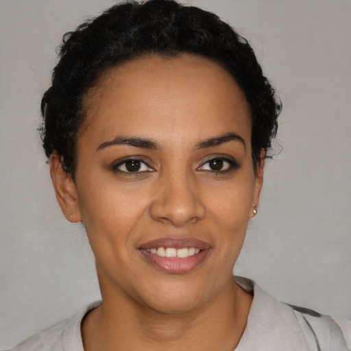 Joyful latino young-adult female with short  brown hair and brown eyes