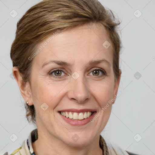 Joyful white adult female with medium  brown hair and grey eyes