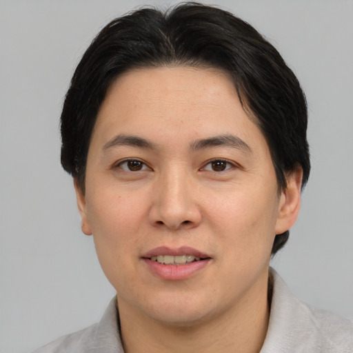 Joyful asian young-adult female with short  brown hair and brown eyes