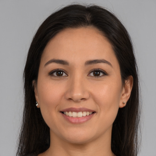 Joyful white young-adult female with long  brown hair and brown eyes