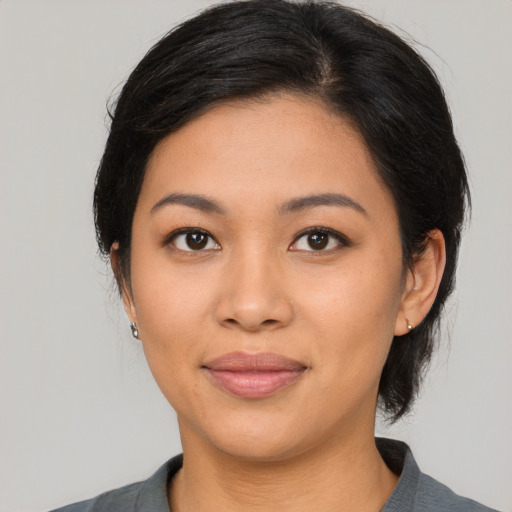 Joyful latino young-adult female with medium  black hair and brown eyes