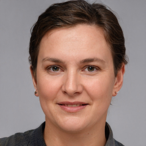 Joyful white adult female with short  brown hair and grey eyes