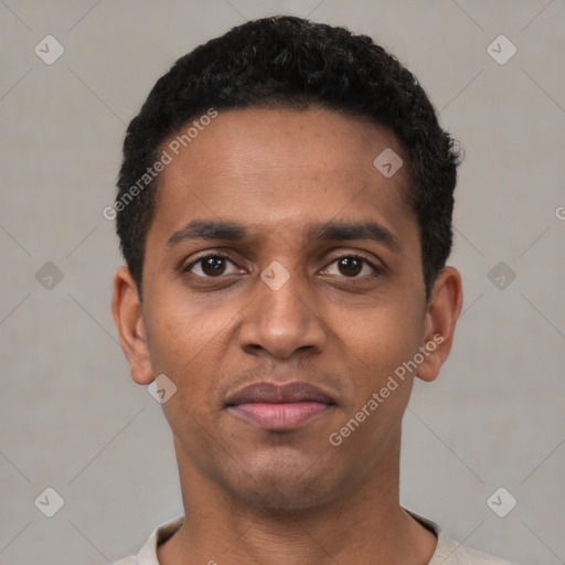 Joyful black young-adult male with short  black hair and brown eyes