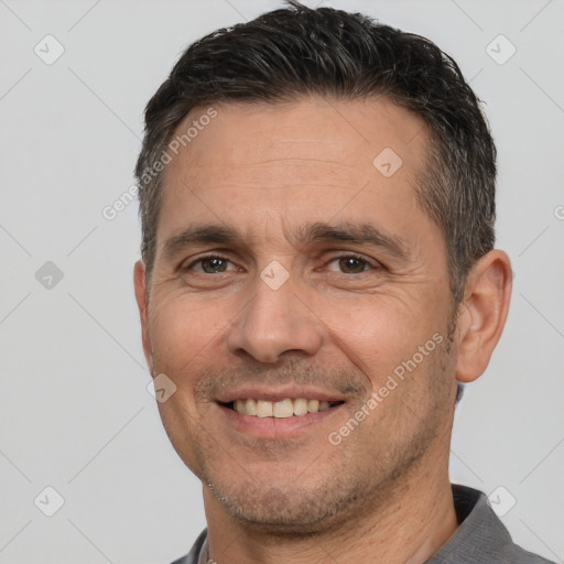 Joyful white adult male with short  brown hair and brown eyes