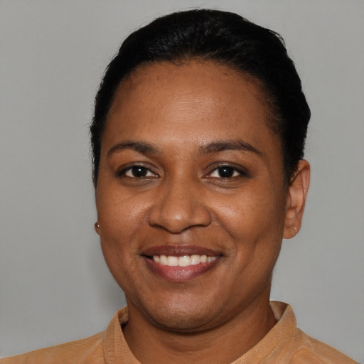 Joyful black young-adult female with short  black hair and brown eyes