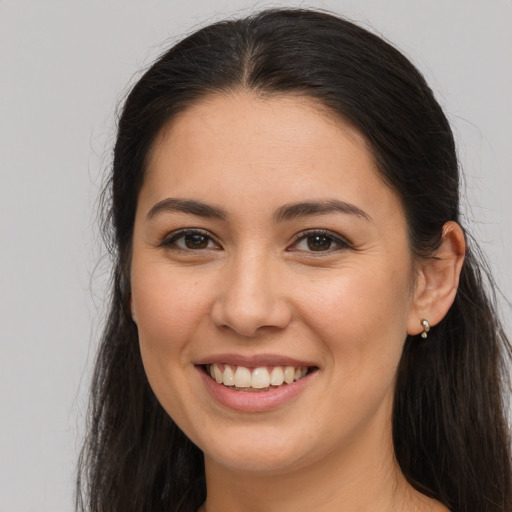 Joyful white young-adult female with long  brown hair and brown eyes