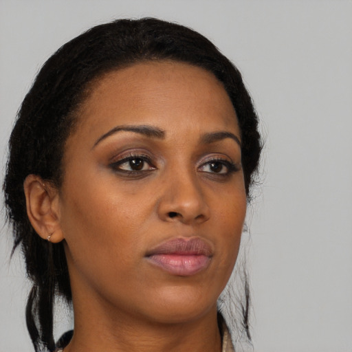 Neutral black young-adult female with medium  brown hair and brown eyes