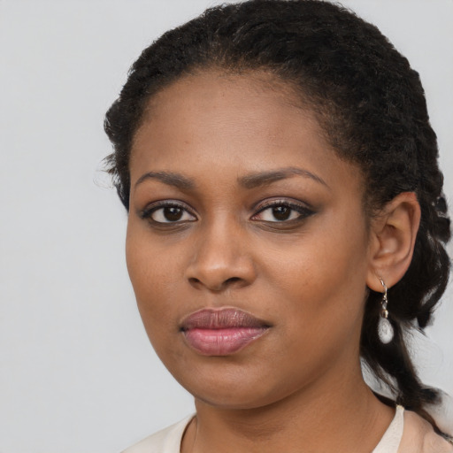 Joyful black young-adult female with medium  black hair and brown eyes