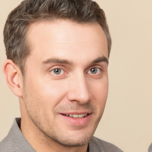 Joyful white young-adult male with short  brown hair and brown eyes