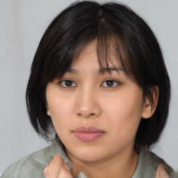 Neutral asian young-adult female with medium  brown hair and brown eyes