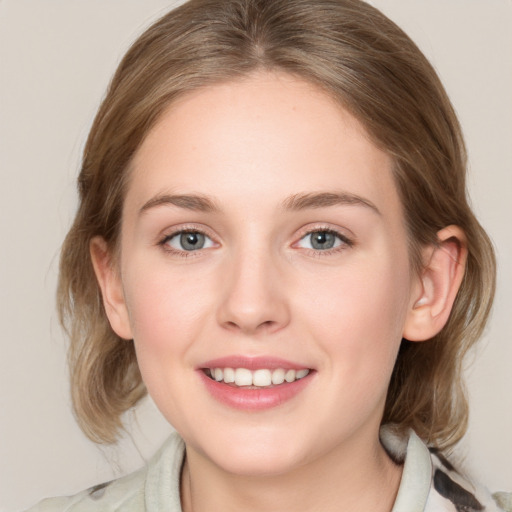 Joyful white young-adult female with medium  brown hair and blue eyes