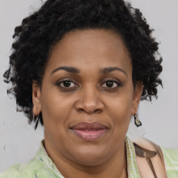 Joyful black adult female with short  brown hair and brown eyes