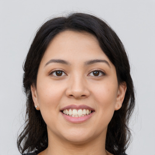 Joyful latino young-adult female with medium  black hair and brown eyes