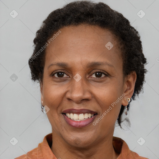 Joyful black adult female with short  brown hair and brown eyes