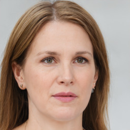 Joyful white young-adult female with medium  brown hair and green eyes