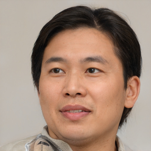 Joyful white adult male with short  brown hair and brown eyes