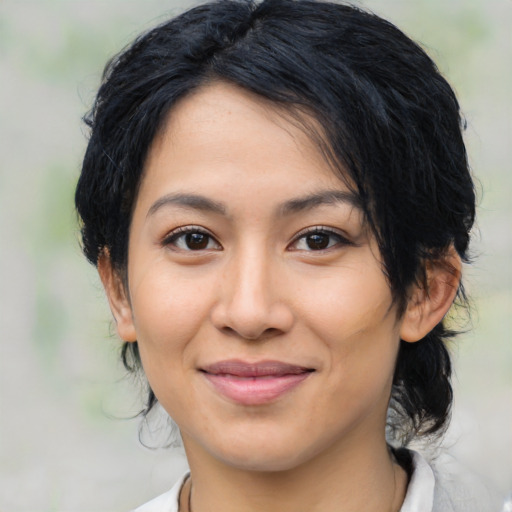 Joyful latino young-adult female with medium  black hair and brown eyes