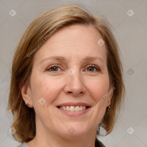 Joyful white adult female with medium  brown hair and blue eyes