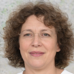 Joyful white middle-aged female with medium  brown hair and brown eyes