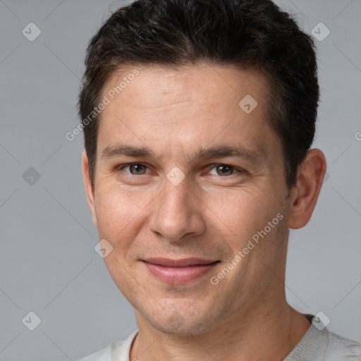 Joyful white adult male with short  brown hair and brown eyes