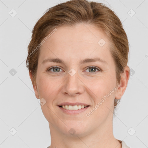 Joyful white adult female with short  brown hair and grey eyes