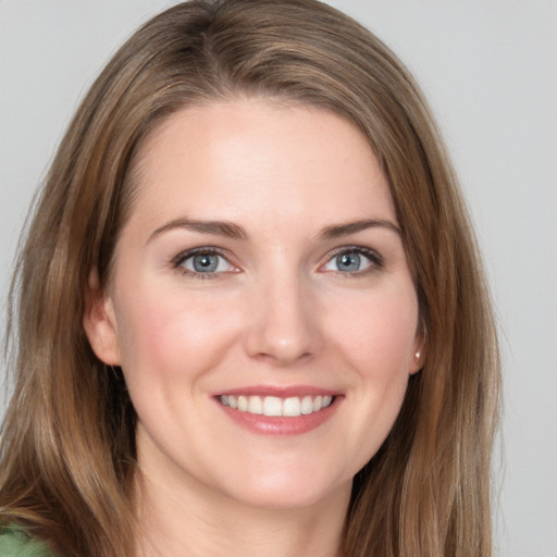 Joyful white young-adult female with long  brown hair and grey eyes