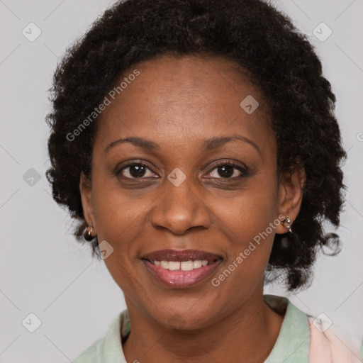 Joyful black adult female with short  black hair and brown eyes