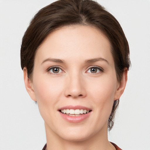 Joyful white young-adult female with short  brown hair and grey eyes