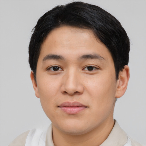 Joyful asian young-adult male with short  black hair and brown eyes