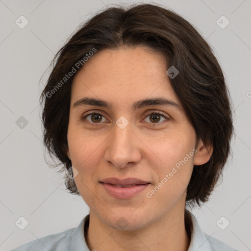 Joyful white adult female with medium  brown hair and brown eyes