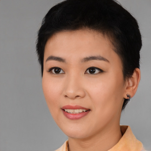 Joyful asian young-adult female with short  black hair and brown eyes