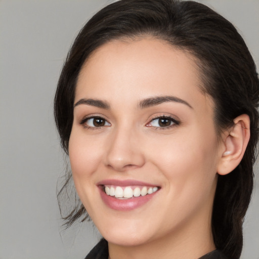 Joyful white young-adult female with long  brown hair and brown eyes