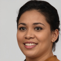 Joyful latino young-adult female with medium  brown hair and brown eyes