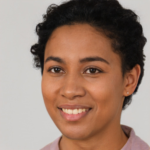Joyful latino young-adult female with short  brown hair and brown eyes