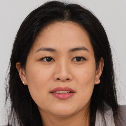 Joyful asian young-adult female with long  brown hair and brown eyes