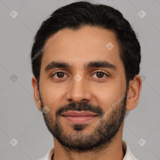 Joyful latino young-adult male with short  black hair and brown eyes