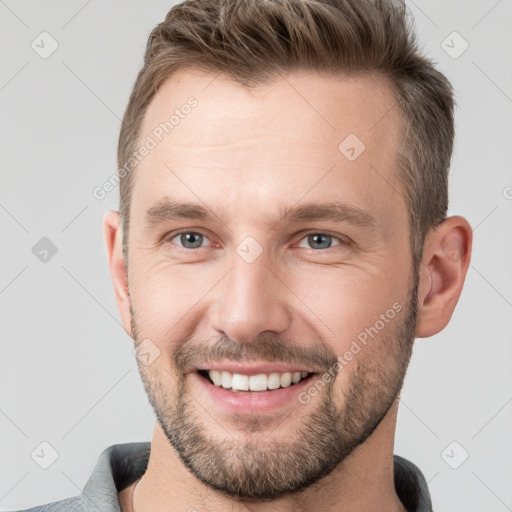 Joyful white young-adult male with short  brown hair and brown eyes