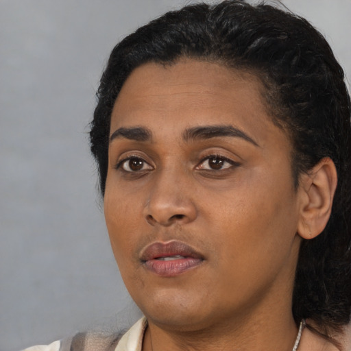 Neutral black young-adult female with short  black hair and brown eyes