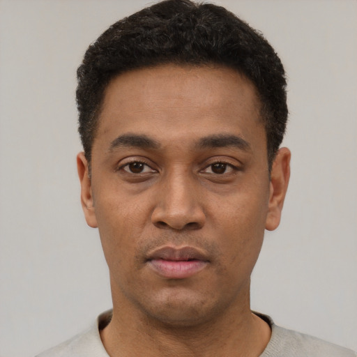 Neutral latino young-adult male with short  black hair and brown eyes