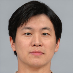 Neutral asian young-adult male with short  brown hair and brown eyes