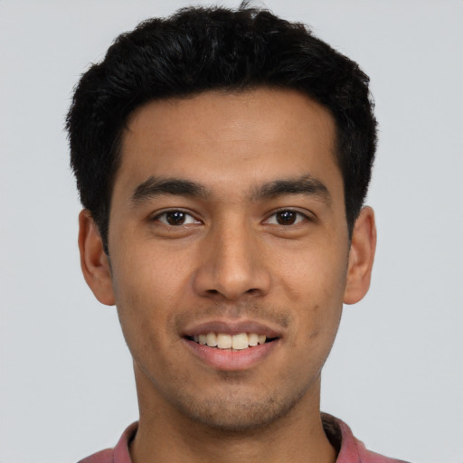 Joyful latino young-adult male with short  black hair and brown eyes