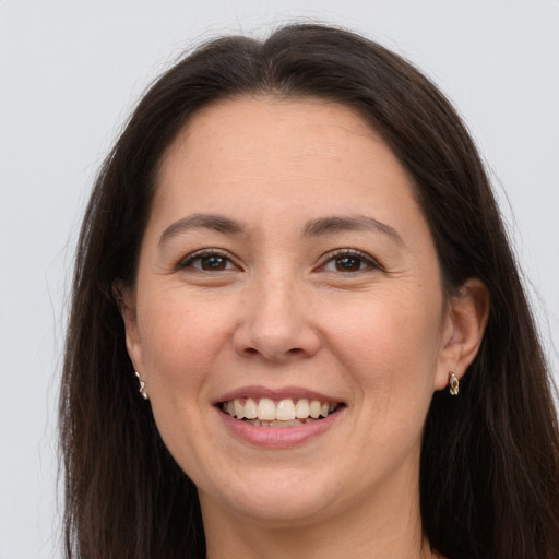 Joyful white young-adult female with long  brown hair and brown eyes