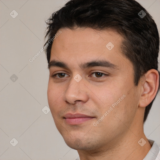 Joyful white young-adult male with short  black hair and brown eyes