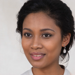 Joyful black young-adult female with medium  brown hair and brown eyes